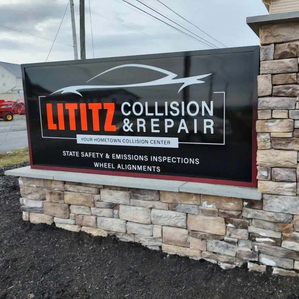 Sign for Lititz Collision & Repair with an outlined car silhouette