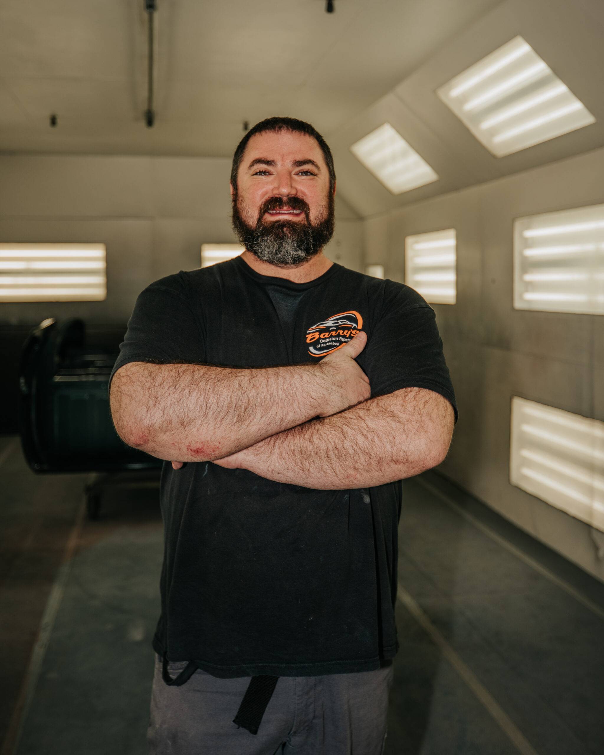 Barry's skilled automotive painter in collision repair shop, part of Barry's Collision Repair team.