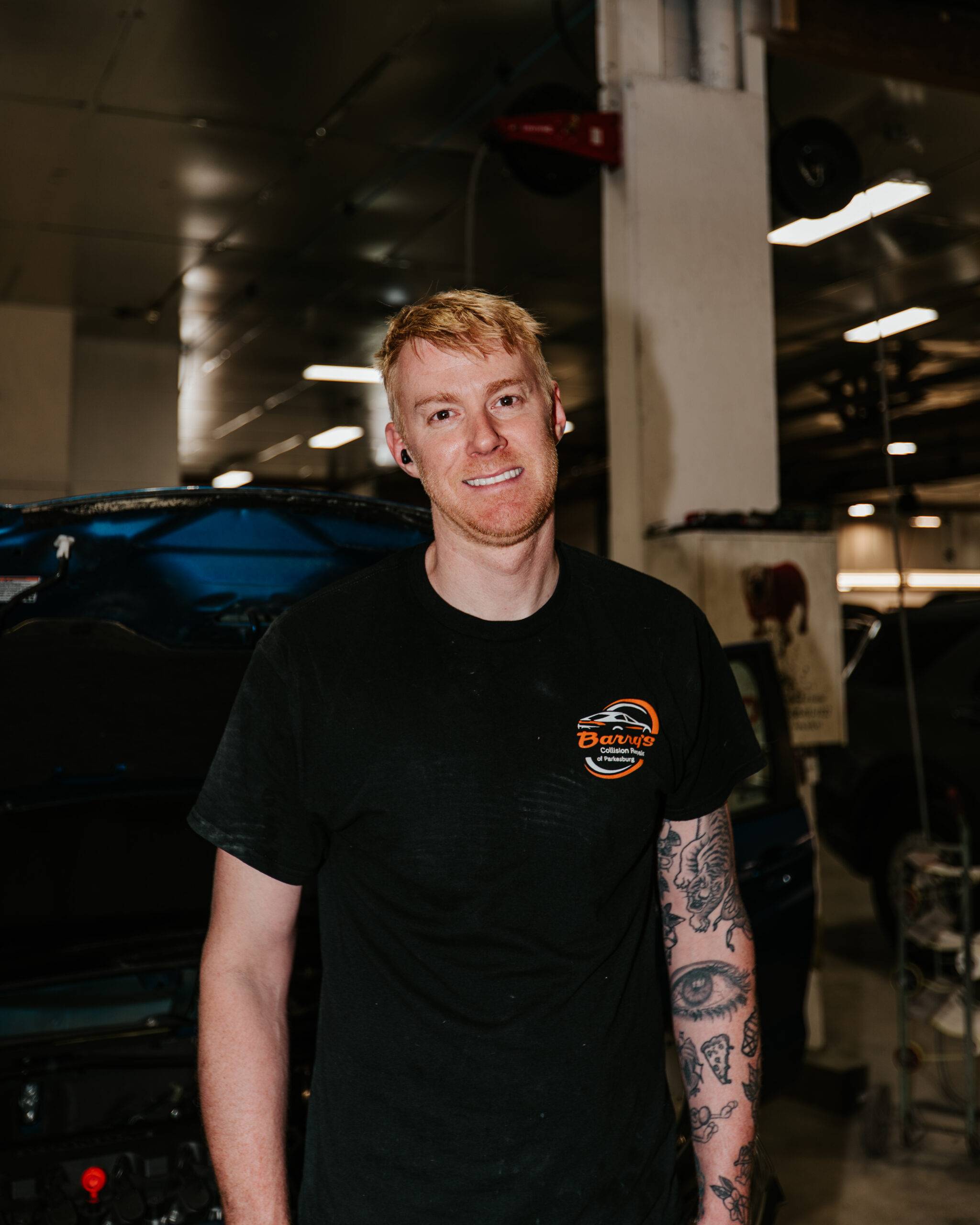 Barry's Collision Repair technician Nate in auto shop, skilled automotive team member.